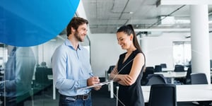 Man and woman standing next to each other smiling 