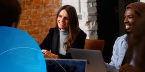 Retorio lady sitting in a meeting smiling 