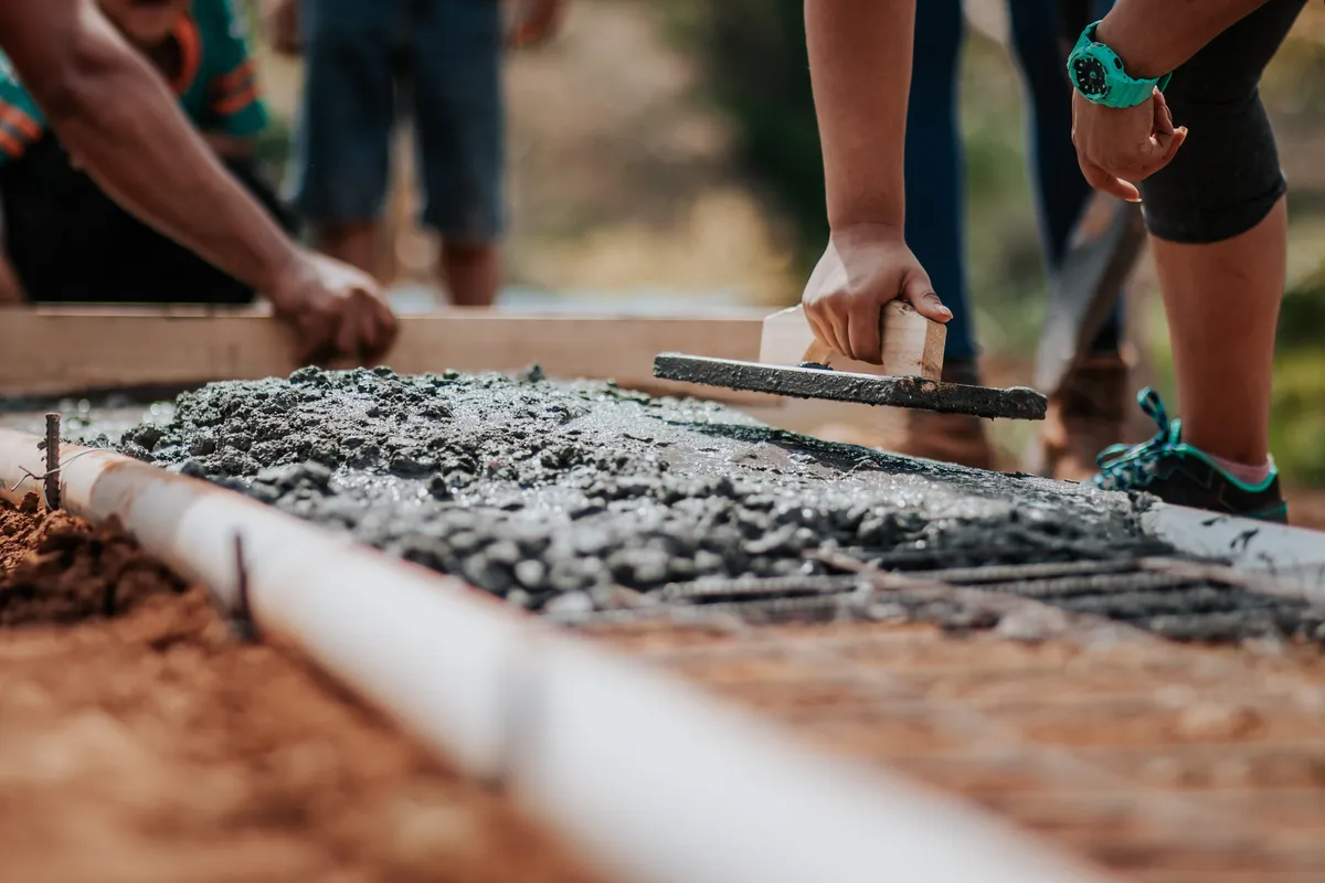 Workers fixing cement